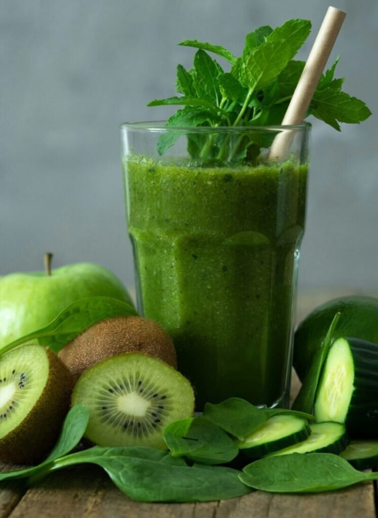 green liquid in clear drinking glass with straw